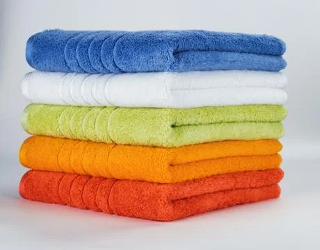 Multicolored towels on a white background Stock Photos