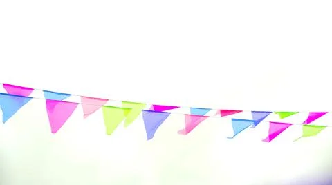 Multicolored triangular flags hang on a string and flutter in the wind agains Stock Photos