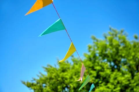 Multicolored triangular paper festival flags Stock Photos