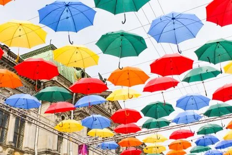 Multicolored umbrellas in the air. Stock Photos