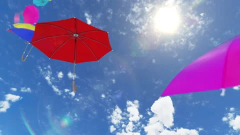 Multicolored umbrellas flying high to the sky against the sun with the wind Stock Footage 158524695