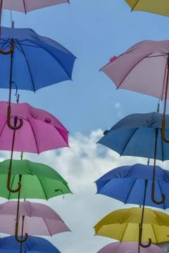 Multicolored umbrellas in the sky Stock Photos