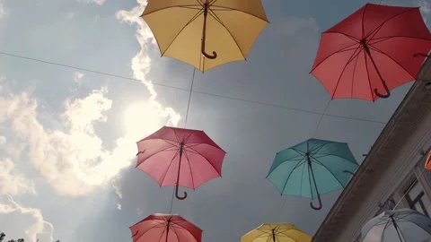 Multicolored umbrellas soar in the sky Stock Footage 195211366