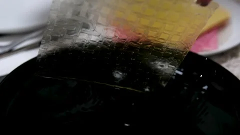 Multicolored yellow rice paper to dip in water to make fresh sprint rolls. black Stock Footage 329281346