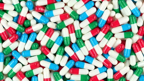 Multicolour capsules top view, rotation. Pills and drugs Stock Footage 253572909