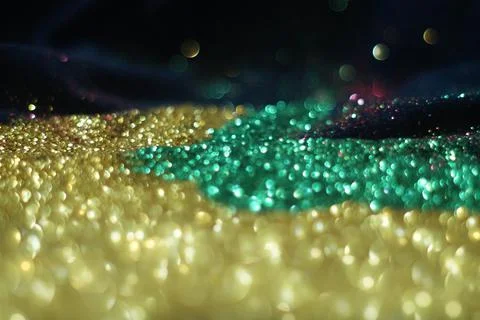 Multicolour glitter on black background and bokeh Stock Photos