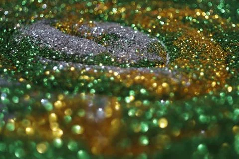 Multicolour glitter on black background Stock Photos