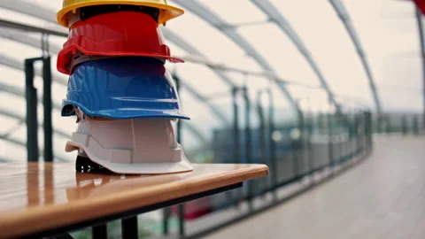 Multicolour Safety Construction Worker Hats. Teamwork of the construction team Stock Footage 143555212