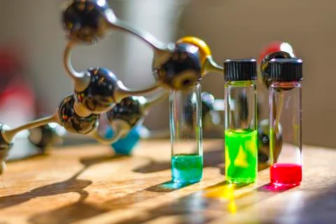 Multicolour solutions in different vials with capillary under the light with  Stock Photos