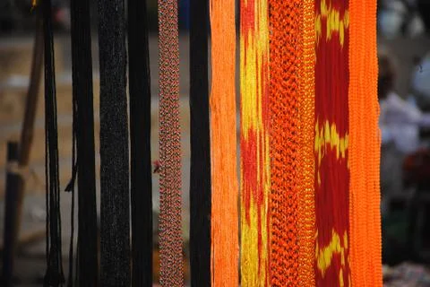 Multicoloured attractive threads hangging in streetside shop Stock Photos
