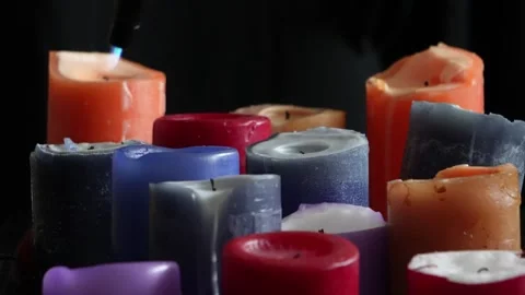 Multicoloured candles burn on a black background. C0228 Stock Footage 255211540