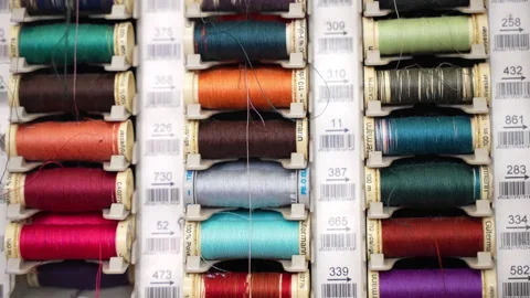 Multicoloured cotton thread reels on vertical board in professional tailor Stock Footage 250019280