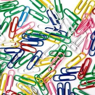 Multicoloured paperclips on the white background Stock Photos