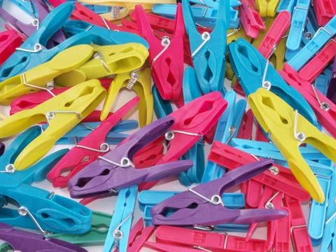 Multicoloured plastic clothes pegs. Stock Photos
