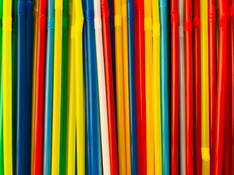 Multicoloured rainbow drinking straws lined up in row. Festive concept, party Stock Photos