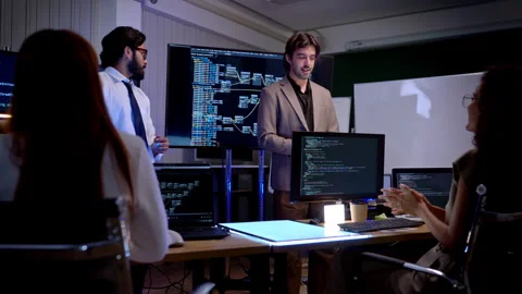 Multicultural business and engineering team discussing software Stock Footage 340462430