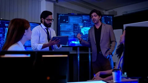 Multicultural business and engineering team discussing software Stock Footage 340464200