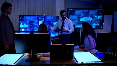 Multicultural business and engineering team discussing software Stock Footage 340464201