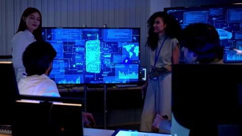Multicultural business and engineering team discussing software Stock Footage 340563680