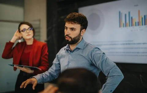 Multicultural business meeting with data presentation in modern office Stock Photos