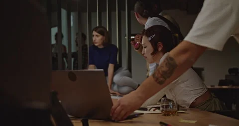 Multicultural Business Team Collaborating on a Project in Office at Night Stock Footage 306784205