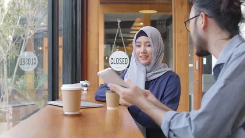 , multicultural cheerful people group talking sit at café table drink coffee Stock Footage 142870336