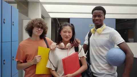 Multicultural classmates in high school. Young teenagers looking at the camera 库存影片 158256725