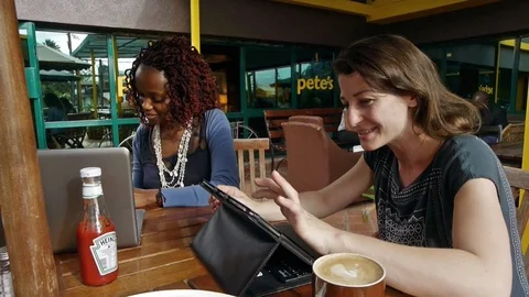 Multicultural co-working: Two women with laptop and tablet in Nairobi Stock Footage 81365003