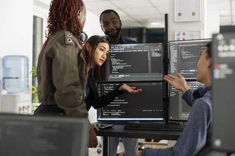 Multicultural coding team working on digital project Foto stock