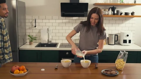 Multicultural couple enjoying breakfast together in the kitchen. Video stock 305049096