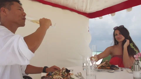 Multicultural Couple Enjoys Romantic Seafood Lunch At Maldivian Seaside Stock Footage 45855086