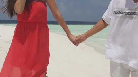 Multicultural Couple Enjoys Their Walk Along White Sand Maldivian Island Stock Footage 45590640