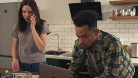 Multicultural couple in the kitchen during a quiet morning. Stock Footage 305653615