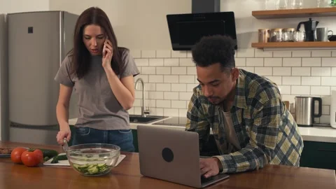 Multicultural couple in the kitchen during a typical morning. Video stock 305654041