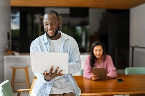Multicultural couple working remotely, planning finances and investments on.. Stock Photos