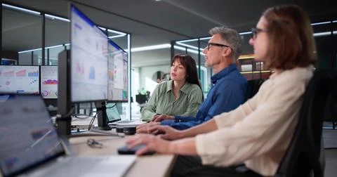 The Multicultural Data Analyst Analyzes Analytics On The KPI Dashboard Stock Photos