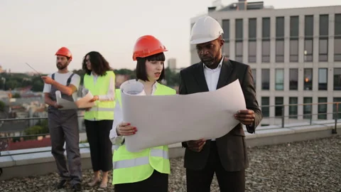 Multicultural developers controlling building quality Stock Footage 246131622