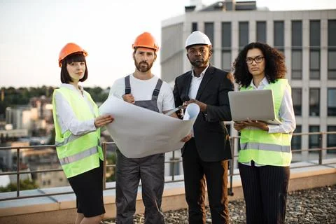 Multicultural developers smiling at camera on terrace Stock Photos