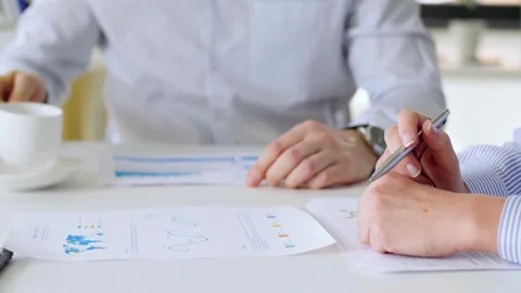 Multicultural employees group work together on project paperwork, Diverse Stock Footage 256742351