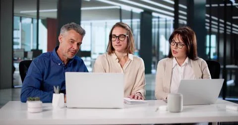 Multicultural Financial Analysts At Work Discussing Business Key Performance  Stock Photos