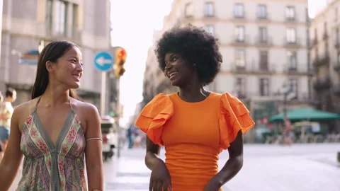 Multicultural friends talking while walking relaxed in the city Stock Footage 255551977
