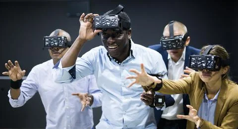 Multicultural friends using virtual reality headsets Stock Photos