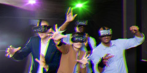 Multicultural friends using virtual reality headsets.Light laser effect Stock Photos