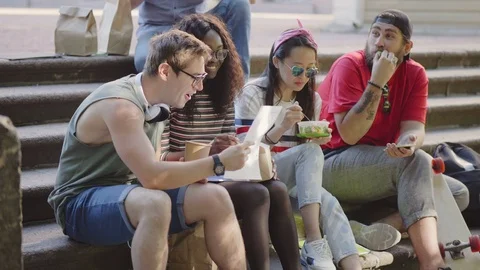 Multicultural group of friends eating Stock Footage 93571064