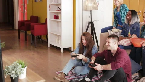 Multicultural group plays in the console game and laughs Stock Footage 88948957