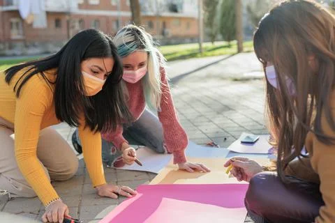 Multicultural group preparing together feminist movement womens international Stock Photos