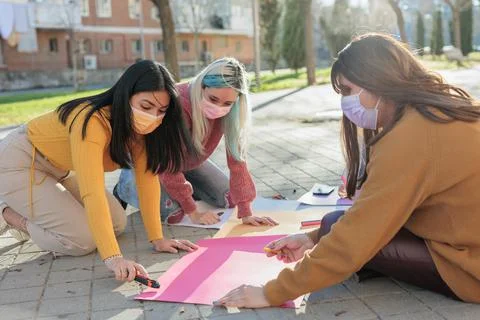 Multicultural group preparing together feminist movement womens international Stock Photos