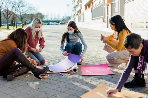 Multicultural group preparing together feminist movement womens international Stock Photos