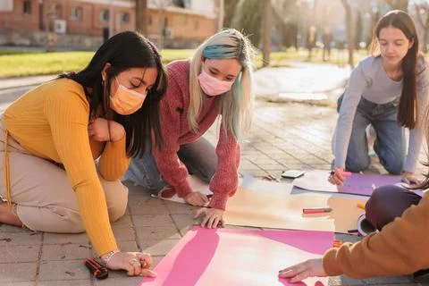 Multicultural group preparing together feminist movement womens international Stock Photos
