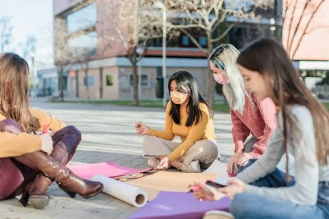Multicultural group preparing together feminist movement womens international Stock Photos